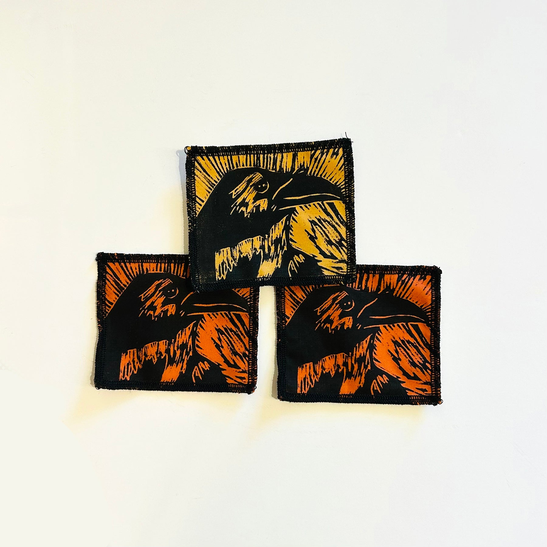 hand printed patch of a crows head