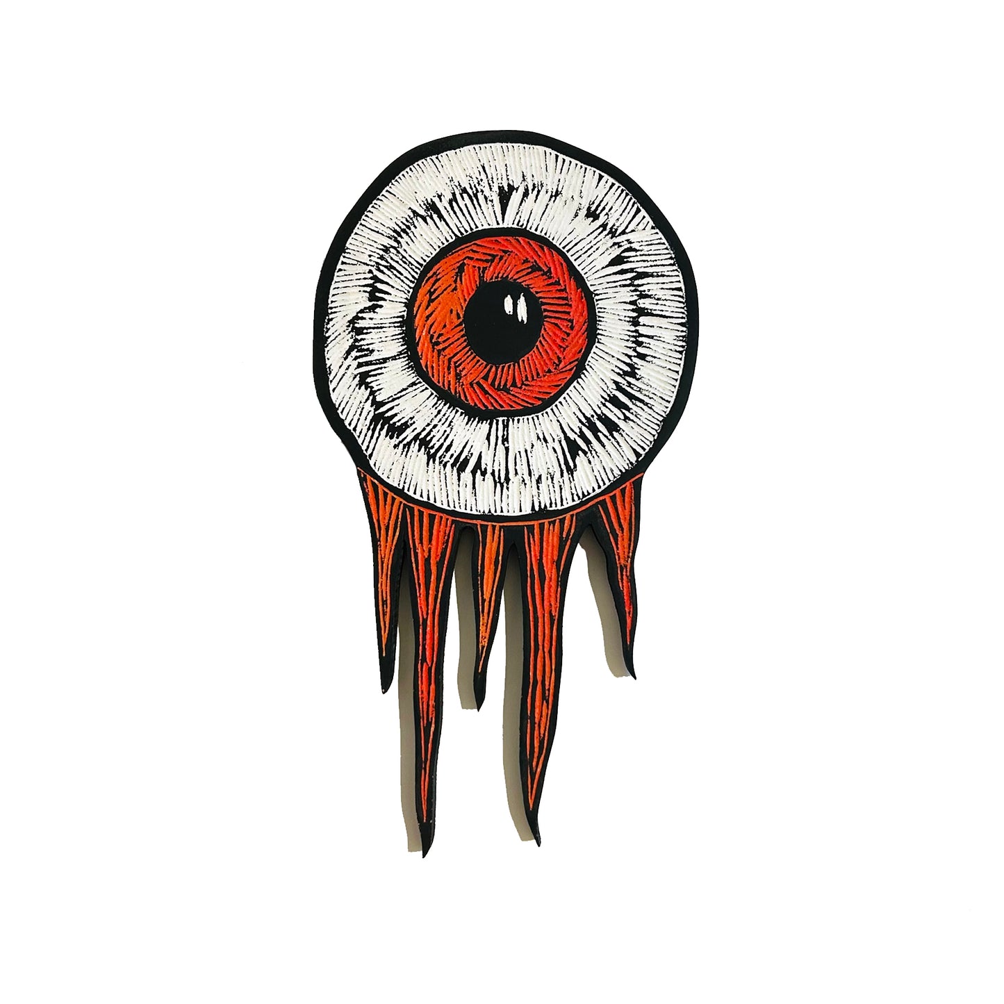 Hand-carved eyeball wood art wall hanging with orange iris and flame-like edges