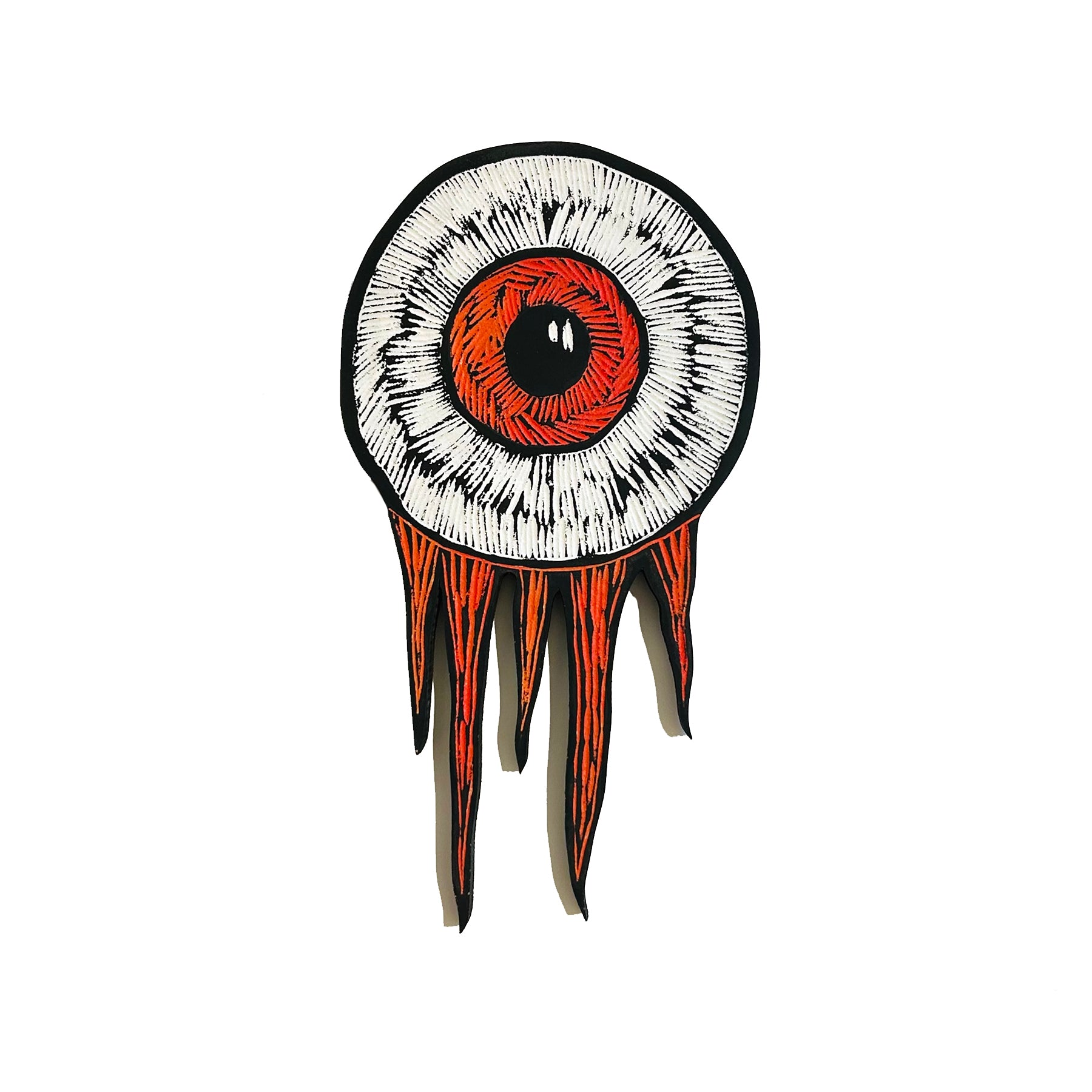 Hand-carved eyeball wood art wall hanging with orange iris and flame-like edges